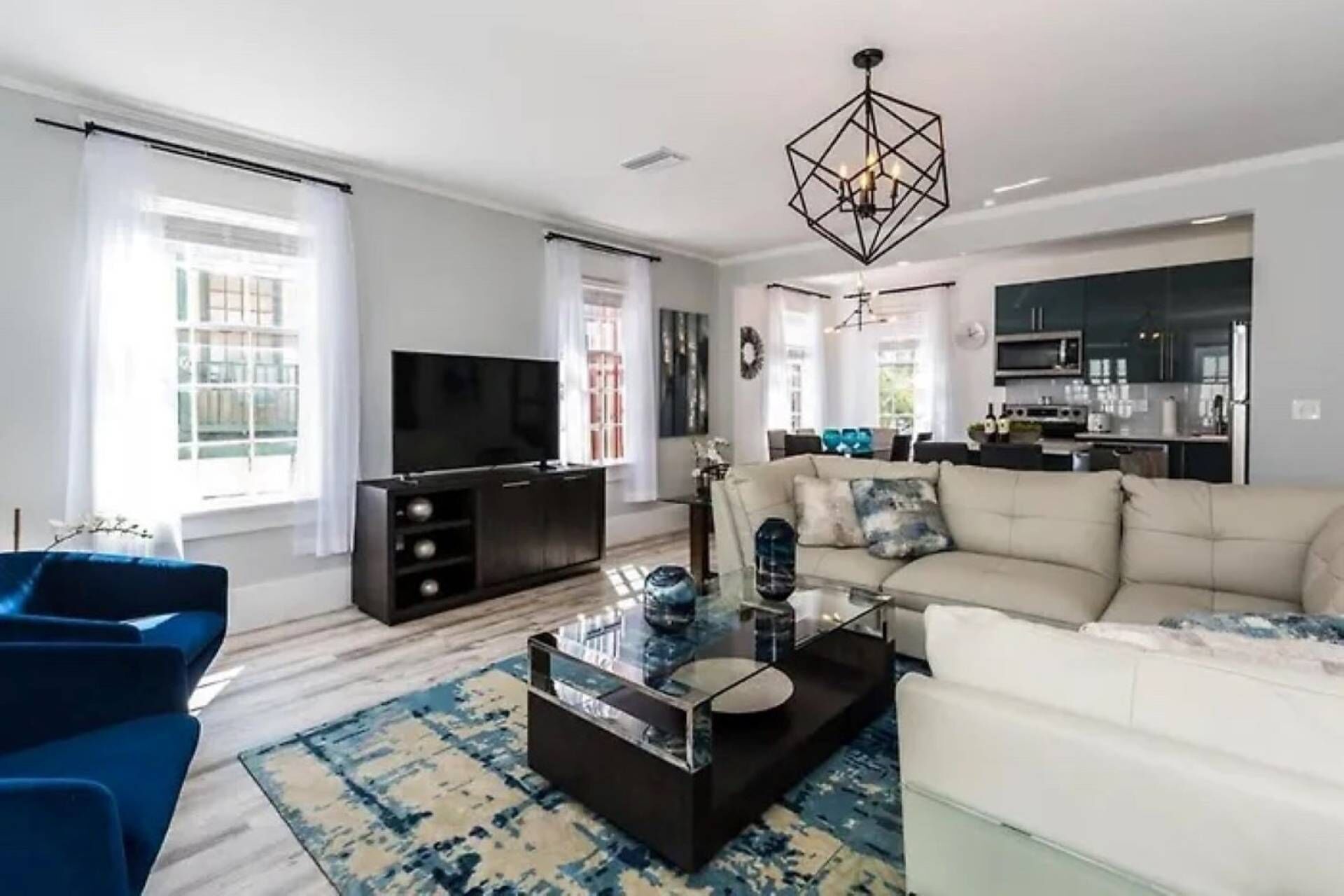 A modern living room with a sofa, a coffee table, and a TV.