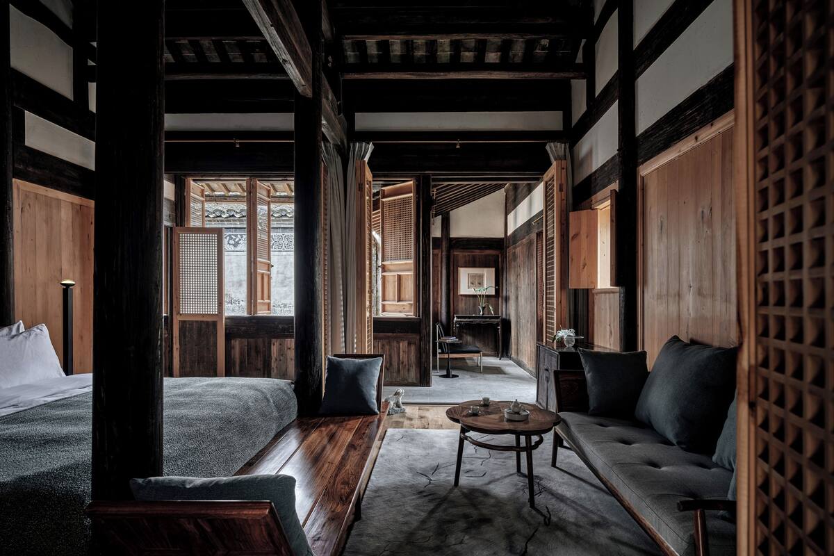 A traditional Japanese-style room with tatami flooring, a low table, and a sofa.