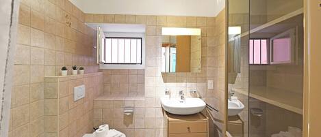 A modern bathroom with a bathtub, sink, and toilet.
