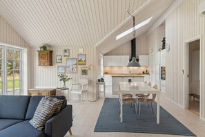 A modern interior with a dining area, kitchen, and living space.