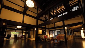 A traditional Japanese-style interior with tatami mat flooring, wooden beams, and shoji screens. - Shinshu Omachi Onsen Ryoan Kawaki (Omachi)