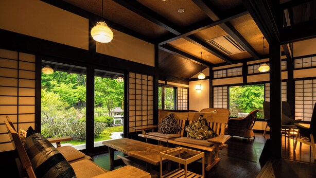 A traditional Japanese-style room with tatami flooring, low wooden tables, and cushions. - Shinshu Omachi Onsen Ryoan Kawaki (Omachi)