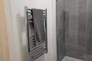 Shower, towels, soap, toilet paper