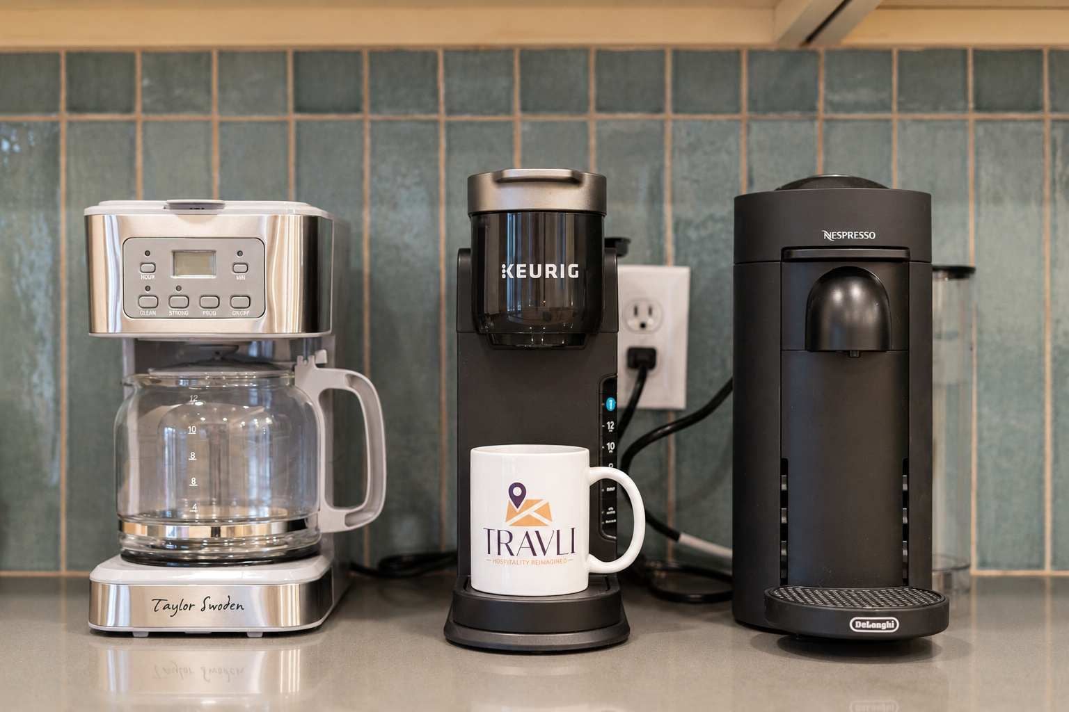 Three coffee makers on a kitchen counter.