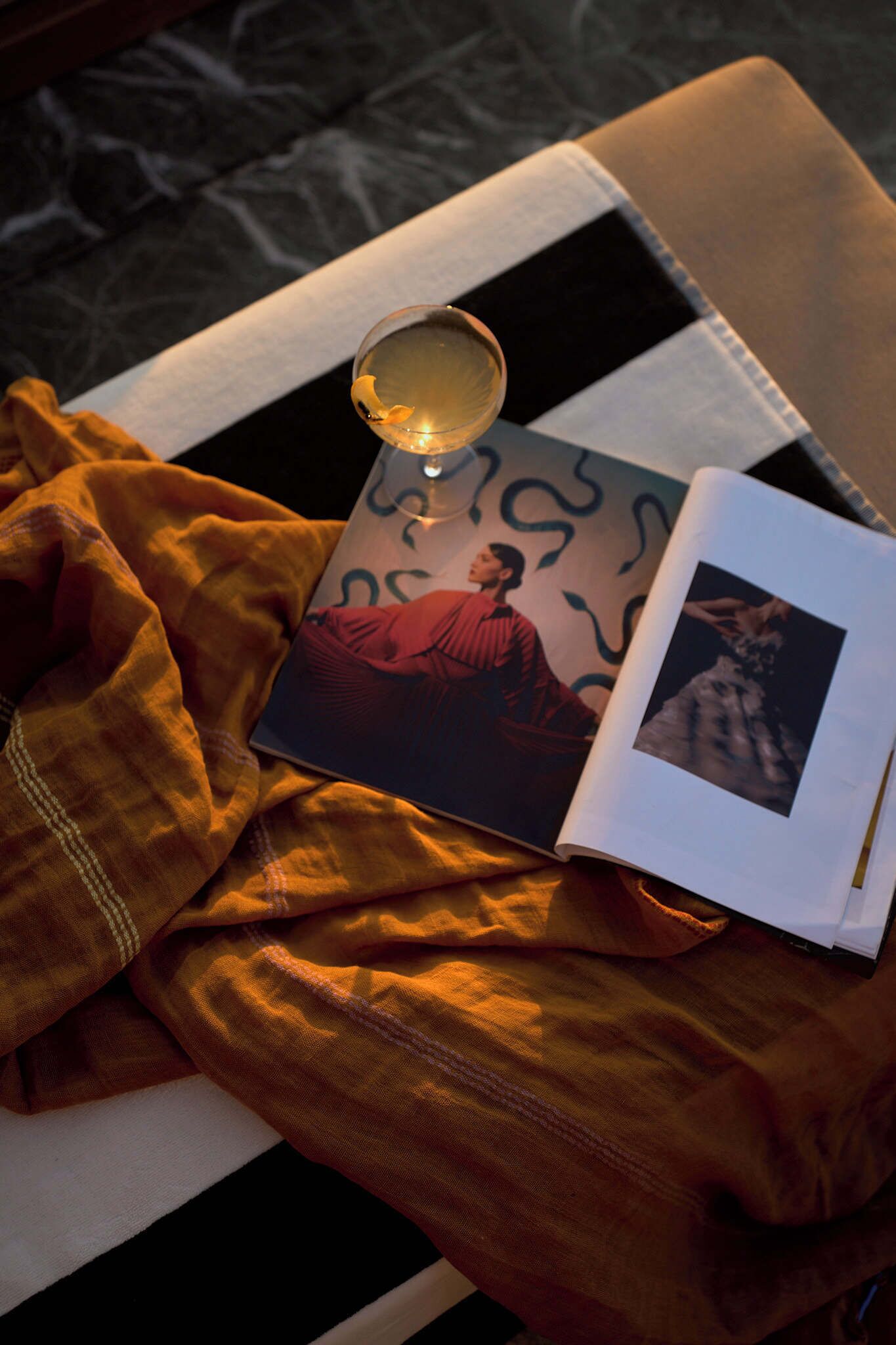 A book with a photograph on a cushion on a chair.