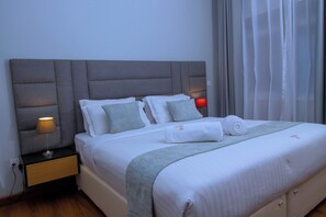 In-room safe, desk, laptop workspace, blackout drapes - The Mansion Hotel (Jinja)