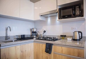 Fridge, microwave, stovetop, coffee/tea maker