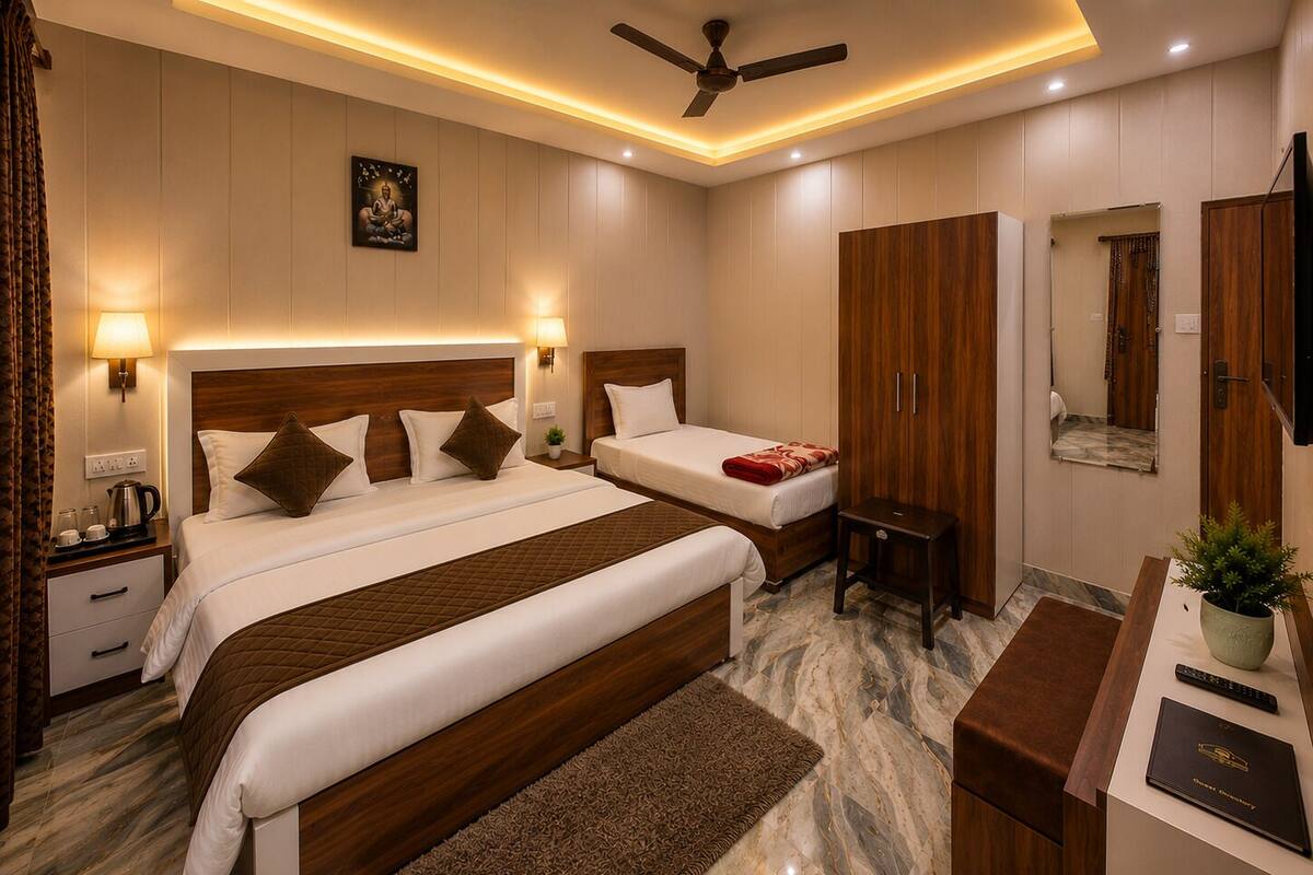 A hotel room with two beds, a desk, a wardrobe, and a ceiling fan.
