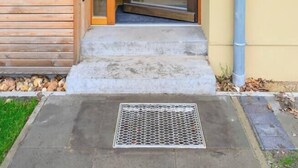 A wooden exterior with a glass door entrance, a metal vent, and a concrete step leading to the door. - Pausenhof Spreewald - pond view with terrace (Unterspreewald)
