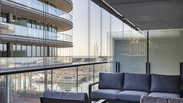 A modern balcony with a sofa and chairs, overlooking a marina with boats. - Waterfront Seaside in Genova (Genoa)