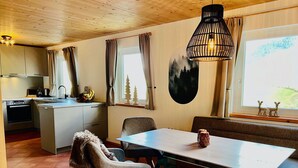 A cozy dining area with a wooden ceiling, a table, chairs, and a bench. - Lovely apartment in villa for 6 guests with WIFI, pool, TV and terrace (Annaberg Im Lammertal)
