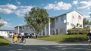 A residential building with a sign reading "Brentwood Hills Luxury Townhouses."