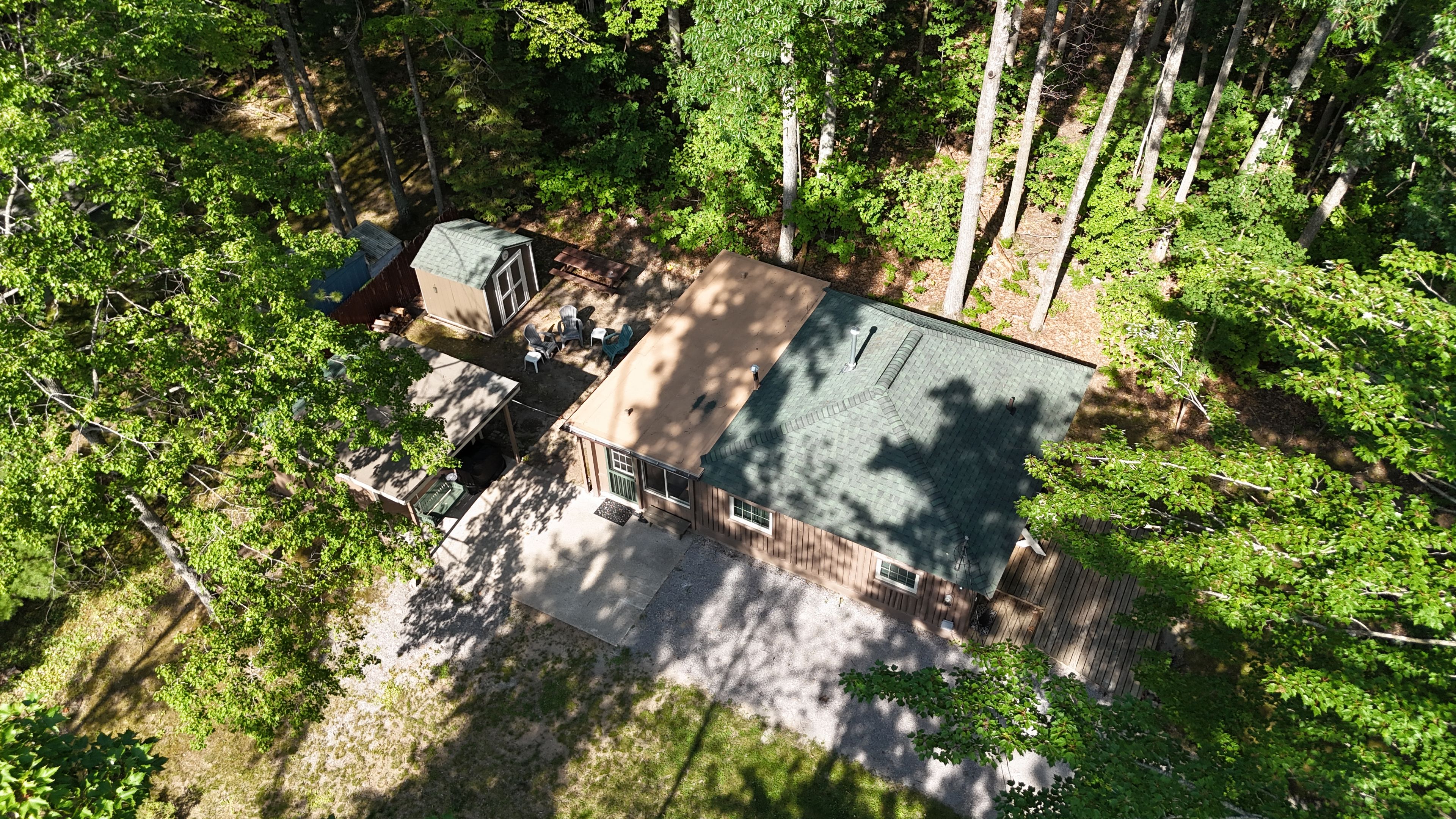 A residential property with a two-story house, a covered patio, and a fenced yard.