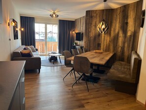Departamento Confort, 3 habitaciones, sauna, vista a la montaña | Área de sala de estar | Televisión de pantalla plana de 50 pulgadas con canales por cable 