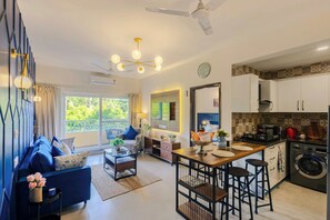 Apartamento luxo, 1 cama Queen, sacada, vista para a piscina | Área de estar | TV de tela plana