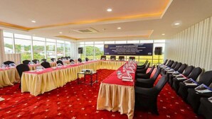 A conference room with a long table, chairs, and a banner. - Labersa Hotel & Convention Centre Toba (Balige)
