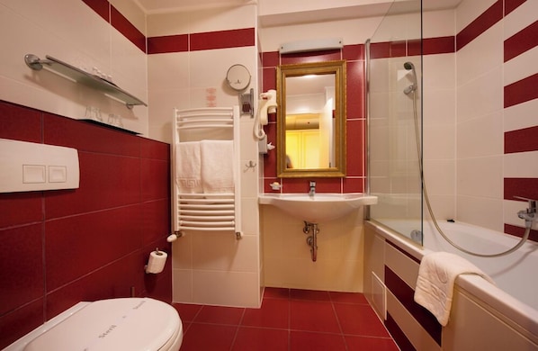 Un baño con inodoro, lavamanos y ducha.