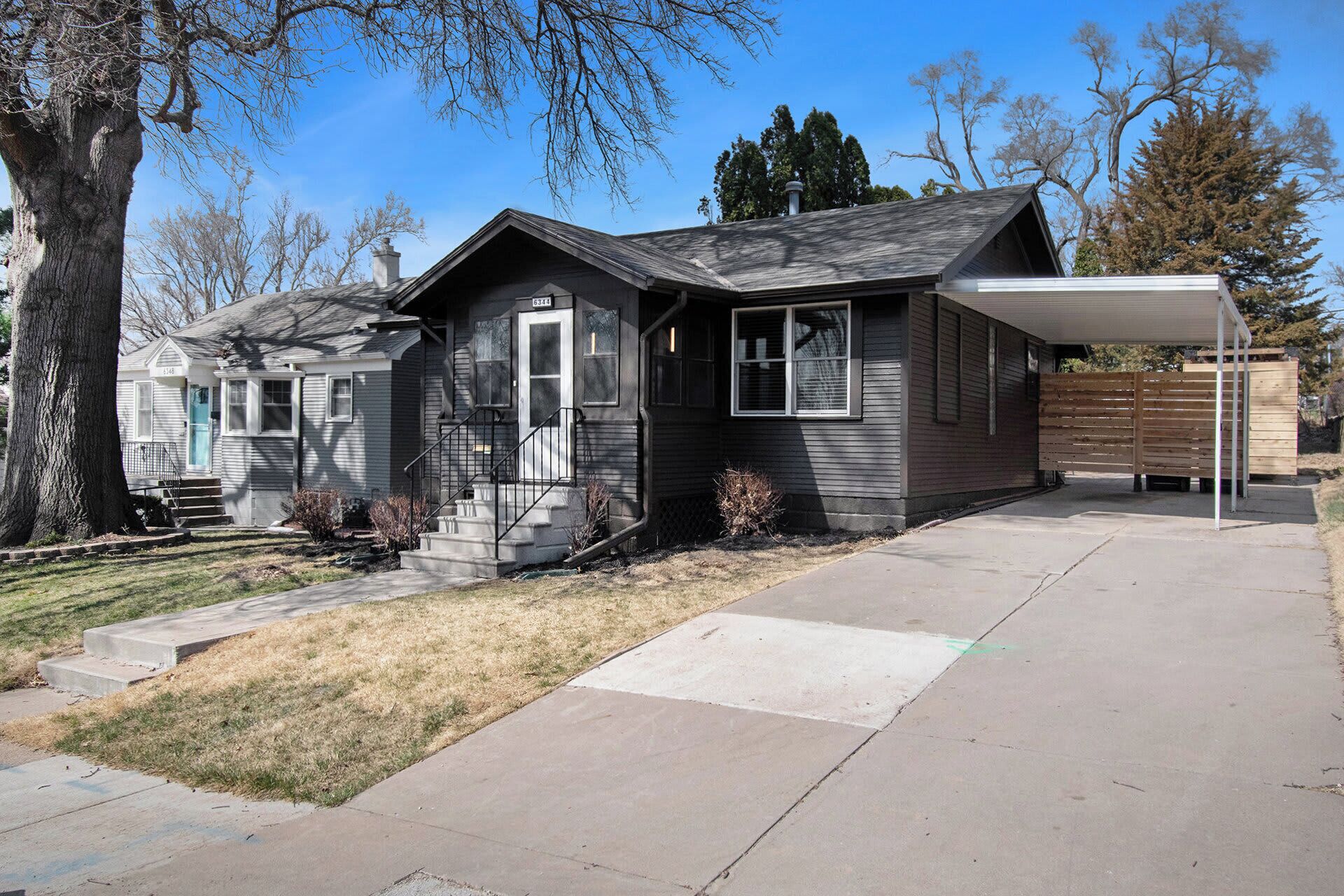 A single-story house with a front porch, a garage, and a covered patio area.