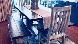 A dining area with a wooden table, chairs, and a chandelier. - Tower 2, three bedroom! Great Views!! FREE BEACH CHAIRS! (Panama City Beach)