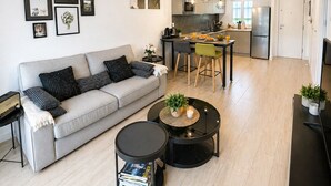 A modern living room with a sofa, coffee table, and artwork on the wall. - Esperanza Grand Apartments II • Marbella Centro (Marbella)