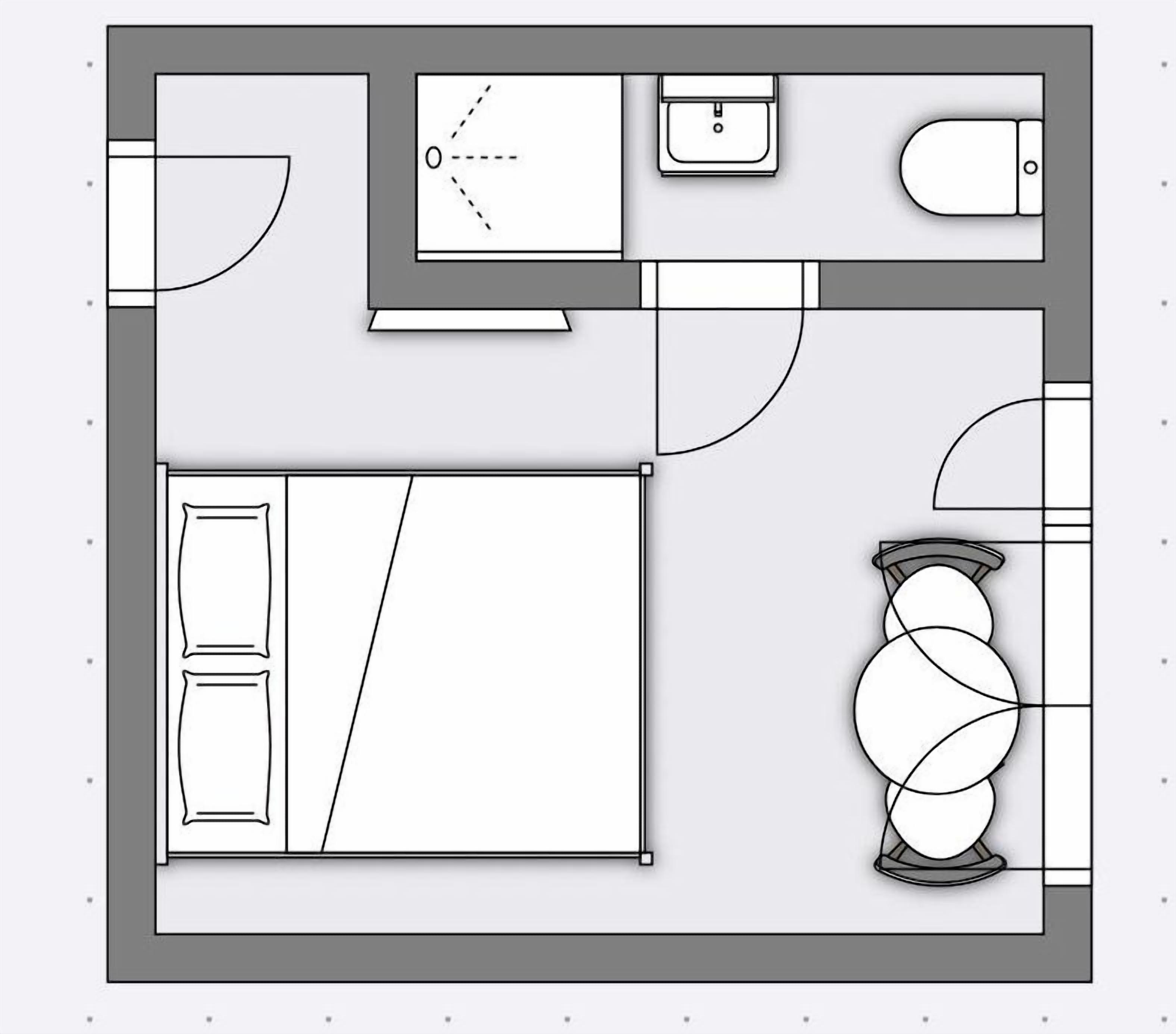 Een plattegrond met een groot bed, een bureau, een stoel, een klein tafeltje en een toilet.