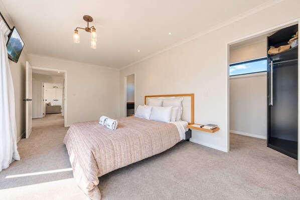 A bedroom with a bed, bedside table, and a wardrobe.