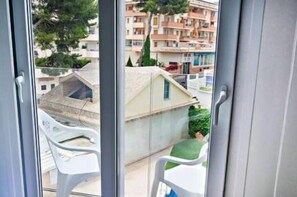 Relax on the balcony with a clear view of the surrounding neighborhood.