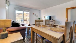 A dining area with a wooden table, chairs, and woven placemats. - Spacious 2 bedroom apartment with sea view! (Municipality of Fuengirola)