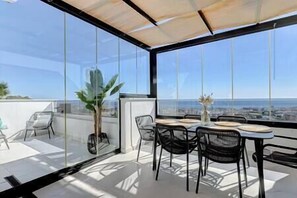 Enjoy meals with a view of the city and sea from this outdoor dining area.
