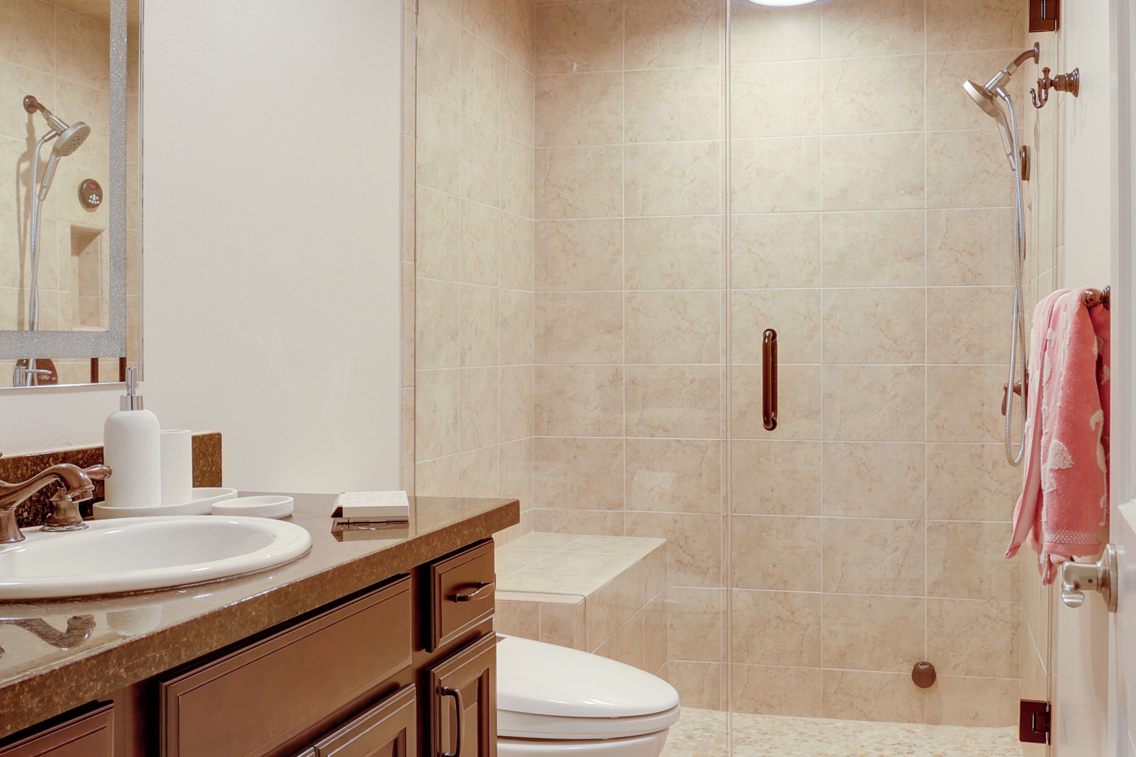 A bathroom with a sink, toilet, and shower.