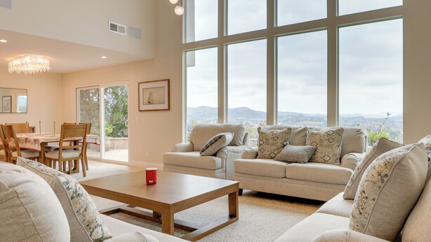 A spacious living room with a large window, a dining area, and a chandelier. - 2 Mi to Promenade at Westlake: Mtn-view Haven! (Westlake Village)