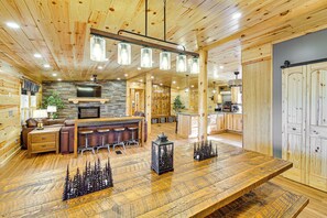 A wooden cabin interior with a dining area, kitchen, and living space. - 11 Mi to Marina on Lake Hamilton: Cabin Getaway (Royal)