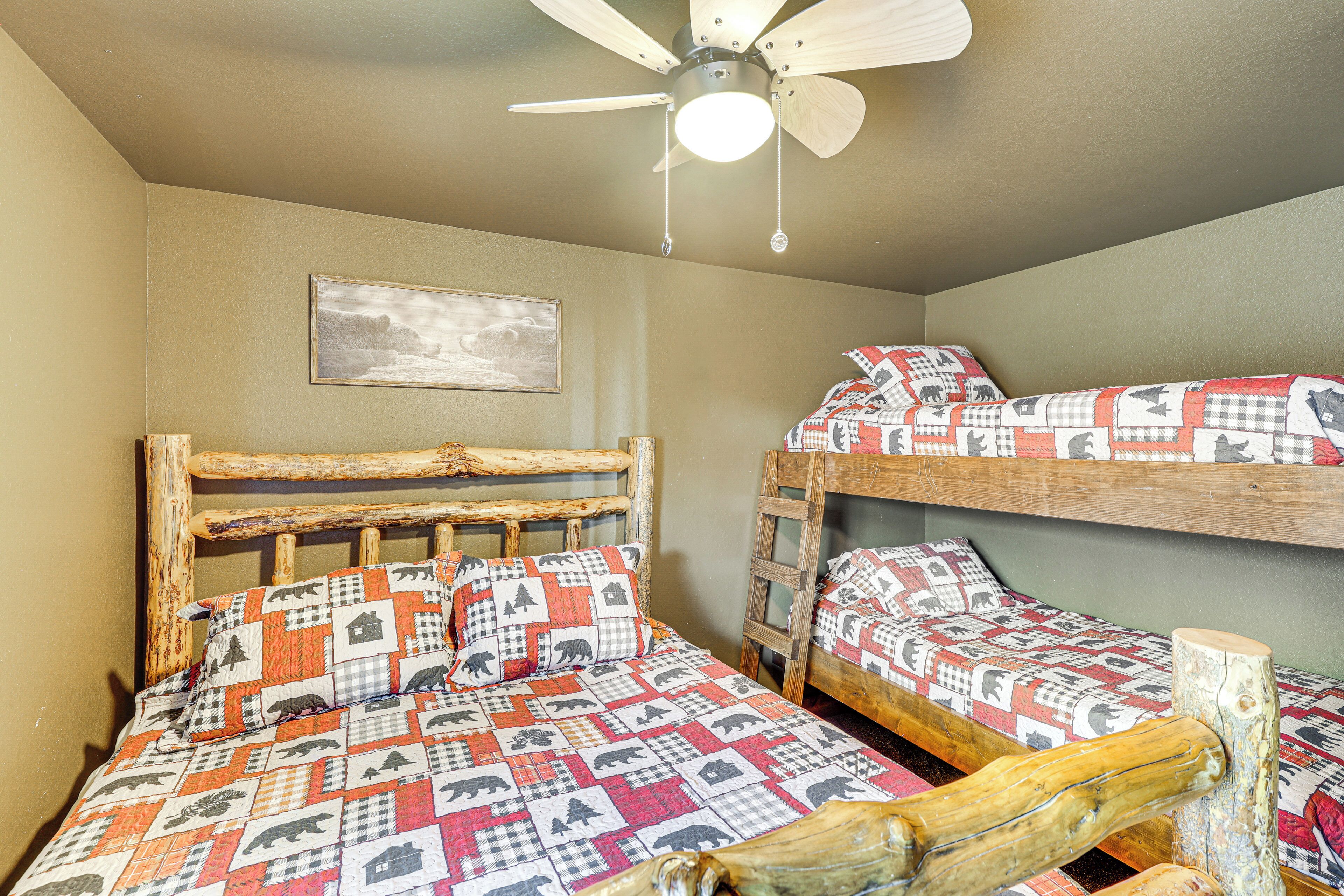 A bedroom with a single bed and a bunk bed, both with patterned bedding.