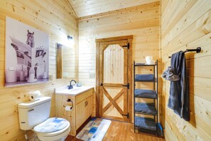 A wooden cabin bathroom with a toilet, sink, and a wooden door. - 31 Mi to Louisville: Cabin on 235 Acres! (La Grange)