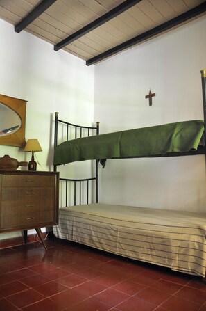 Cozy room with a bunk bed, dresser, and mirror.
