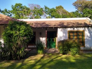 Guesthouse surrounded by lush greenery, blending seamlessly into its natural surroundings.