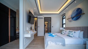 A modern bedroom with a large bed, bedside tables, a TV, and a wall-mounted artwork. - FIFTH ELEMENT pool villa by NLA (Choeng Thale)