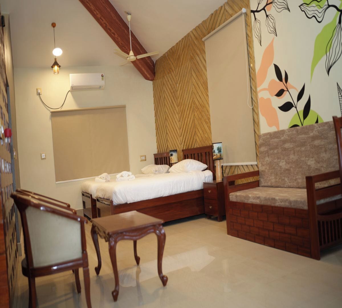 A bedroom with a bed, wooden furniture, a ceiling fan, and a wall-mounted air conditioner.