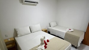 A hotel room with two beds, a bedside table, an air conditioning unit, and a tiled floor. - Pousada e Flat Diamant's (Ipojuca)