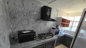 A kitchen with a built-in oven, a microwave, and a gas stove.
