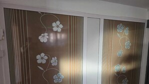 Habitación con puerta corredera que presenta motivos florales y líneas verticales.