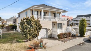 A two-story house with a balcony, a front porch, and a garage.