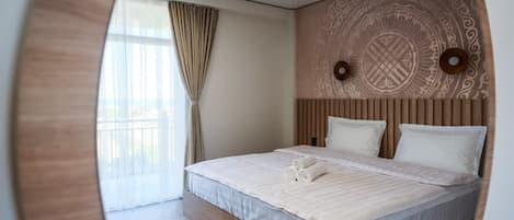 A modern bedroom with a wooden headboard, a large bed with white linens, and a patterned wall design.