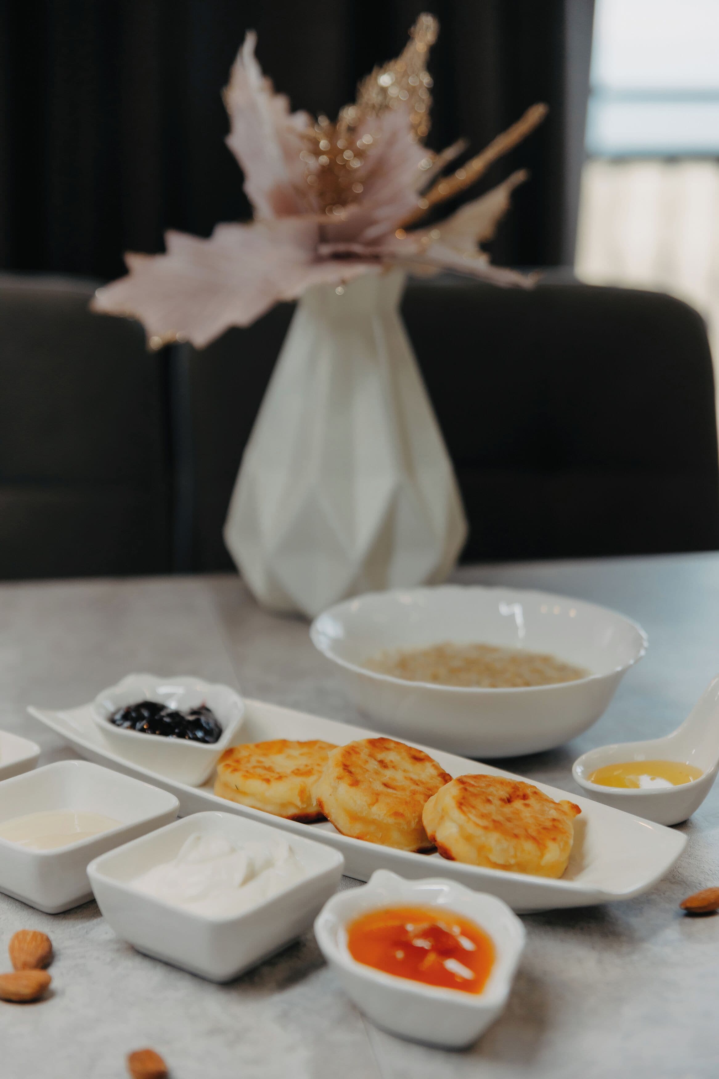 A table with pastries and small bowls of condiments.