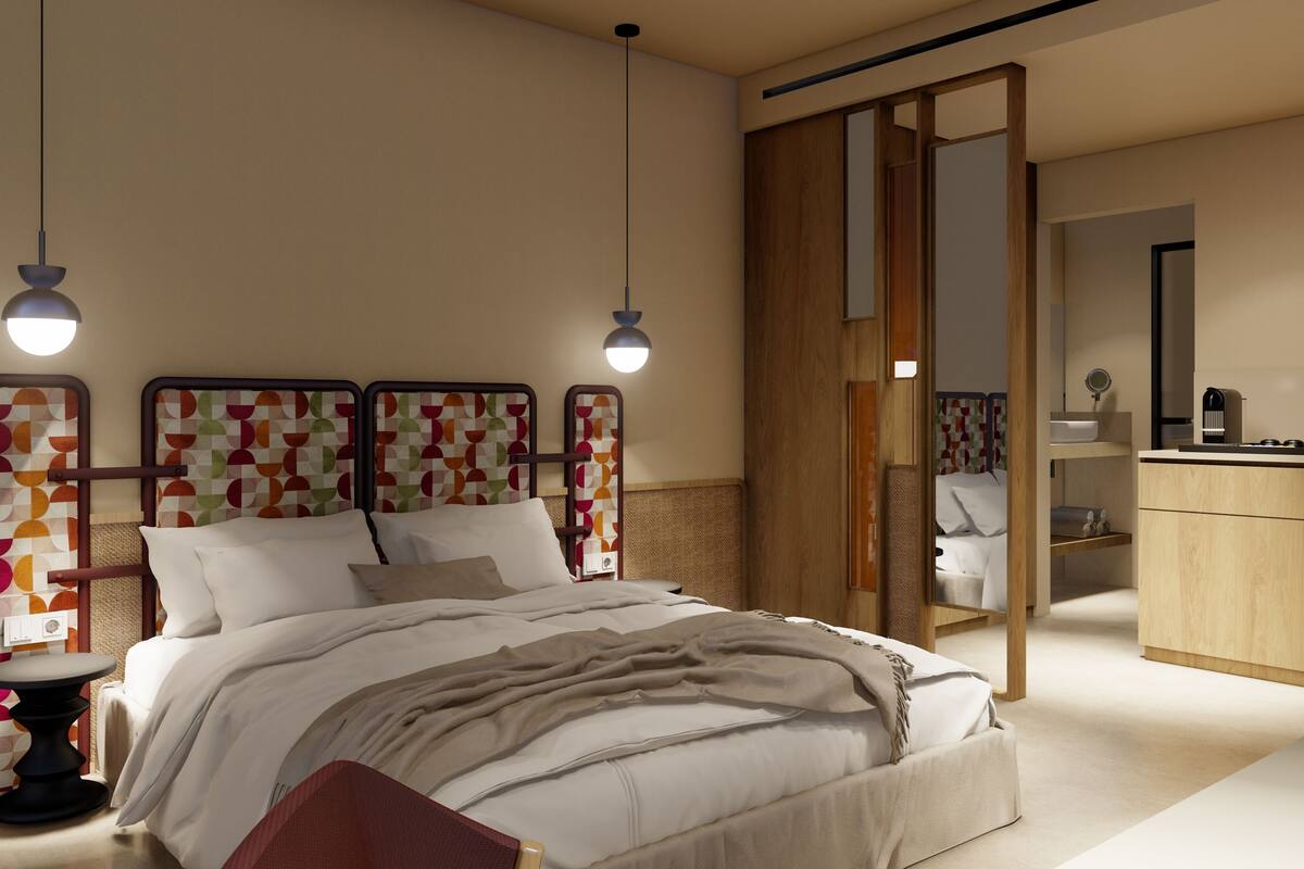 A modern bedroom with a bed, bedside tables, a wardrobe, and a mirror.