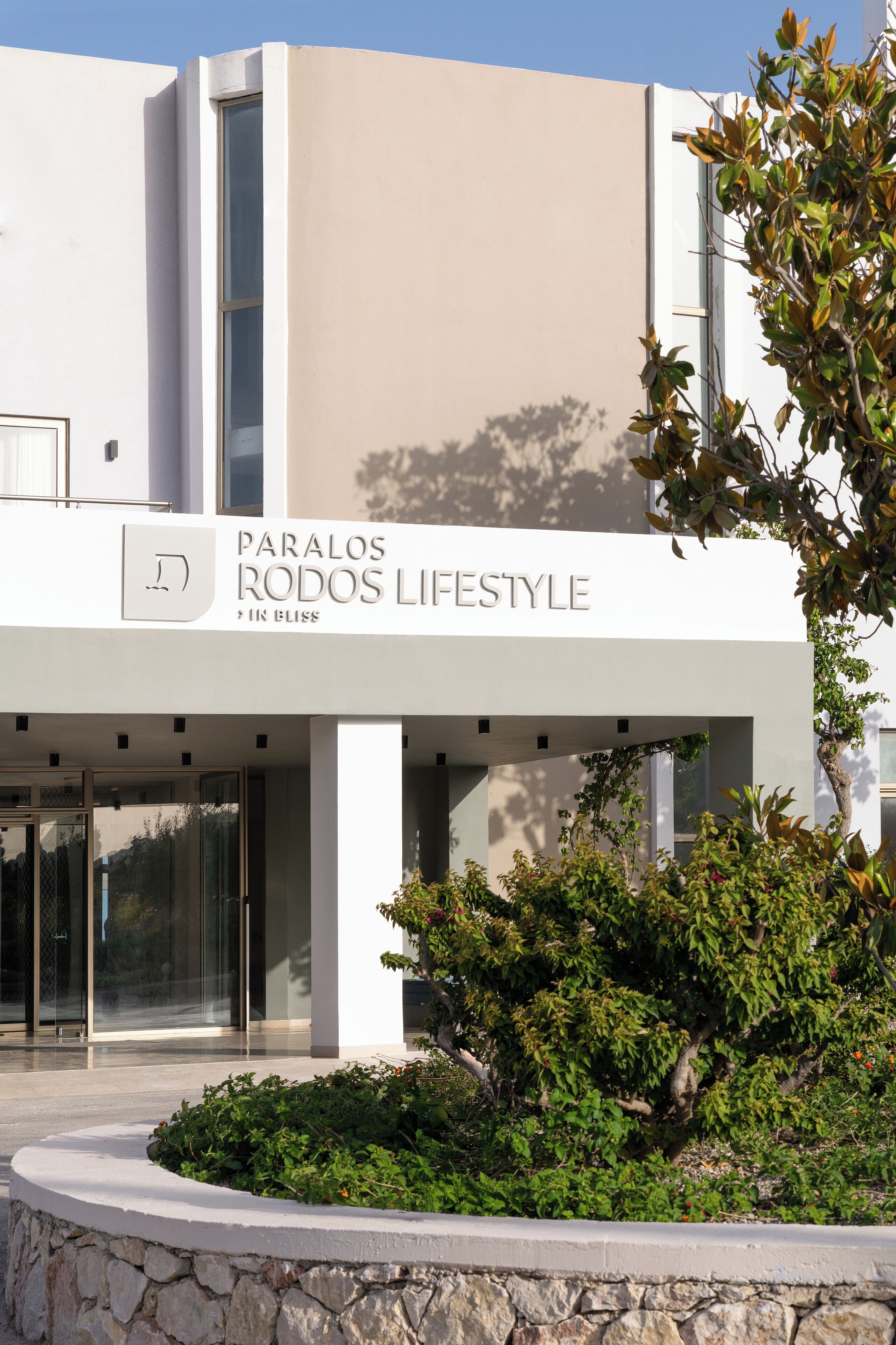 A modern building with a sign reading 'Paralos Rodos Lifestyle & In Bliss'.