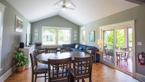 A spacious living room with a dining area, a ceiling fan, and large windows. - The Viceroy - 45 Butternut (Prince Edward)
