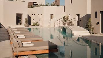Seasonal outdoor pool, open 8:00 AM to 8:00 PM, pool umbrellas