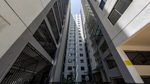 A high-rise building with multiple floors, featuring a modern architectural design with large windows and balconies. - Erica Suites - Riverside 1BR Apartments (Nairobi)