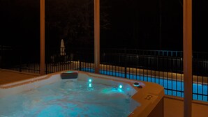 A hot tub with a view of a swimming pool and a fence. - Luxury 6,000+ sq ft Hideaway with Heated Pool, Spa, & Sauna - near Greenville (Taylors)